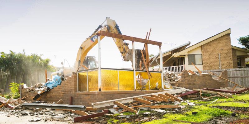 bulldozer knocking down structure for a knockdown rebuild home. Best knockdown rebuild builder Brisbane. knockdown rebuild expert Cleveland. Leafe Designer homes is an expert at knockdown rebuild