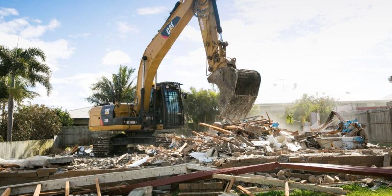 bulldozer knocking down housing structure for knockdown rebuild project. knockdown rebuild expert Thornlands. knockdown rebuild projects Redlands. Knockdown rebuild builder Logan. Leafe Designer homes is an expert at knockdown rebuild