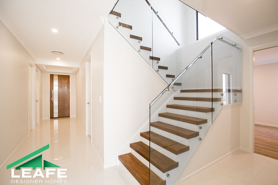wood and glass staircase in sloping block build. sloping block builds by custom home builder, leafe designer homes. custom home builder Thornlands, custom home builder Cornubia, custom home builder daisy hill. 